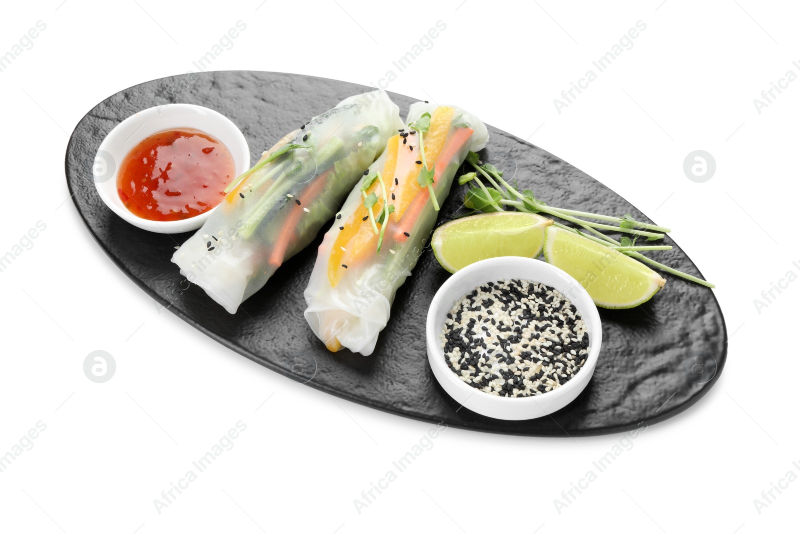 Photo of Tasty spring rolls, sauce, lime, sesame seeds and microgreens isolated on white