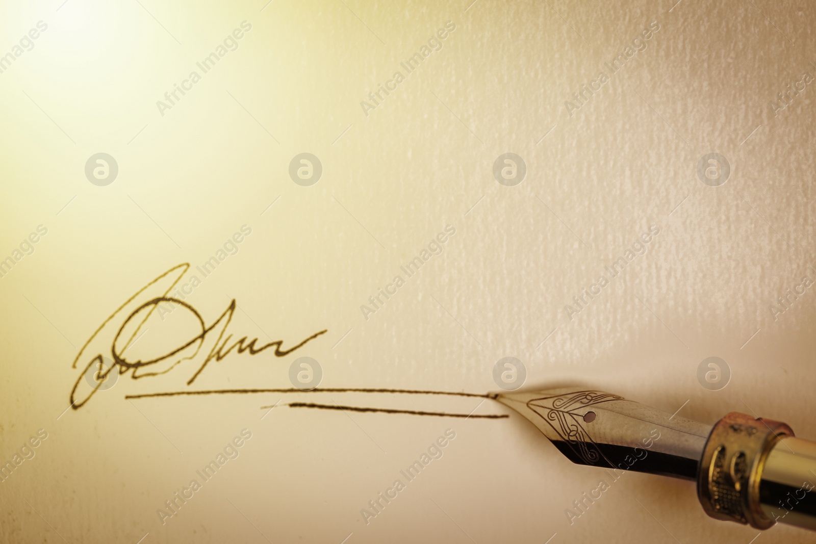 Image of Signing on sheet of paper with fountain pen, top view. Space for text