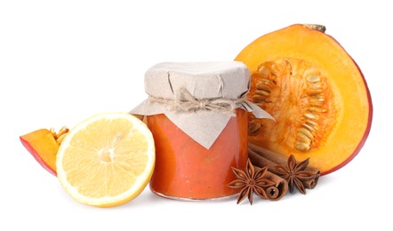 Jar of pumpkin jam and ingredients on white background