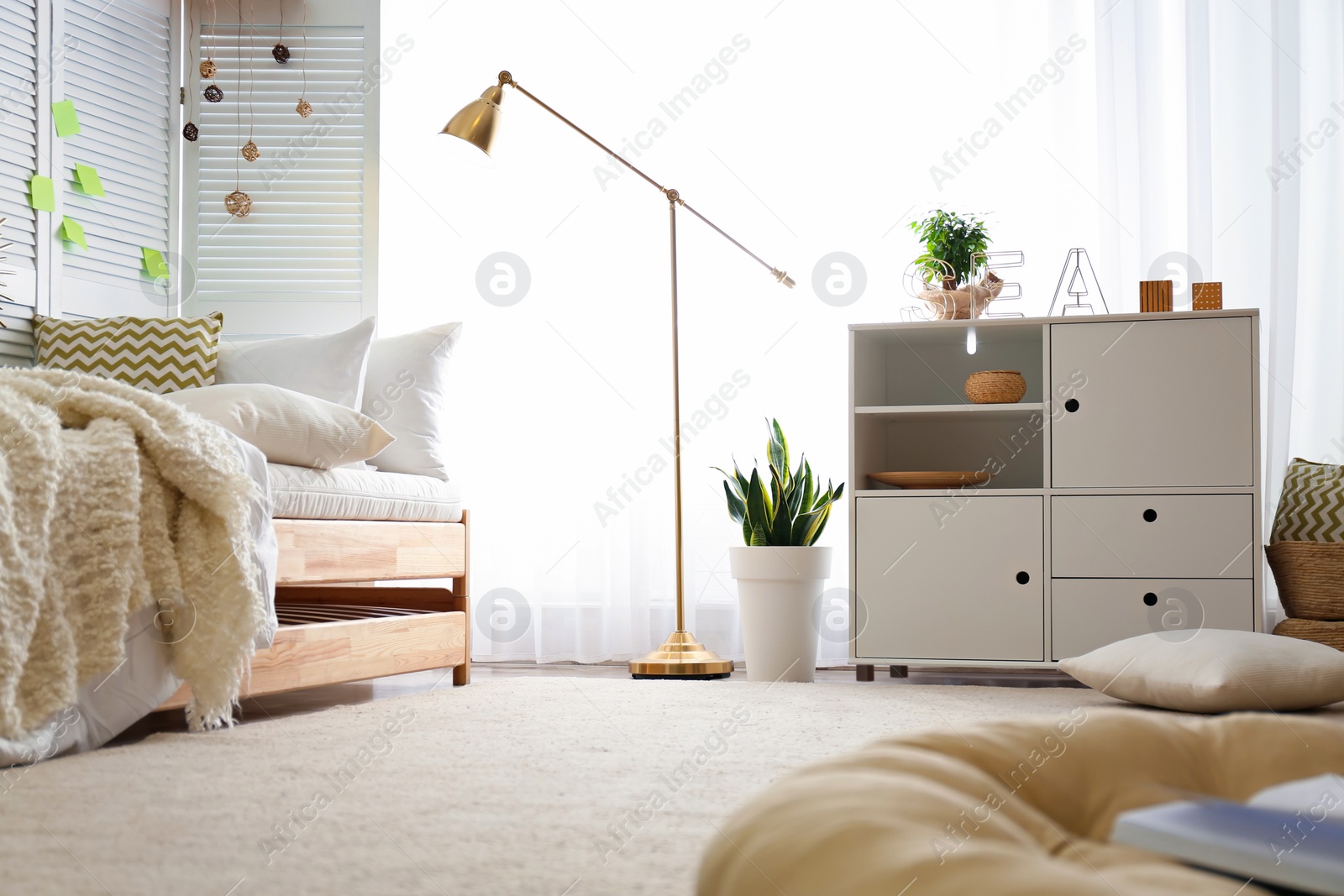 Photo of Stylish chest of drawers in bedroom interior