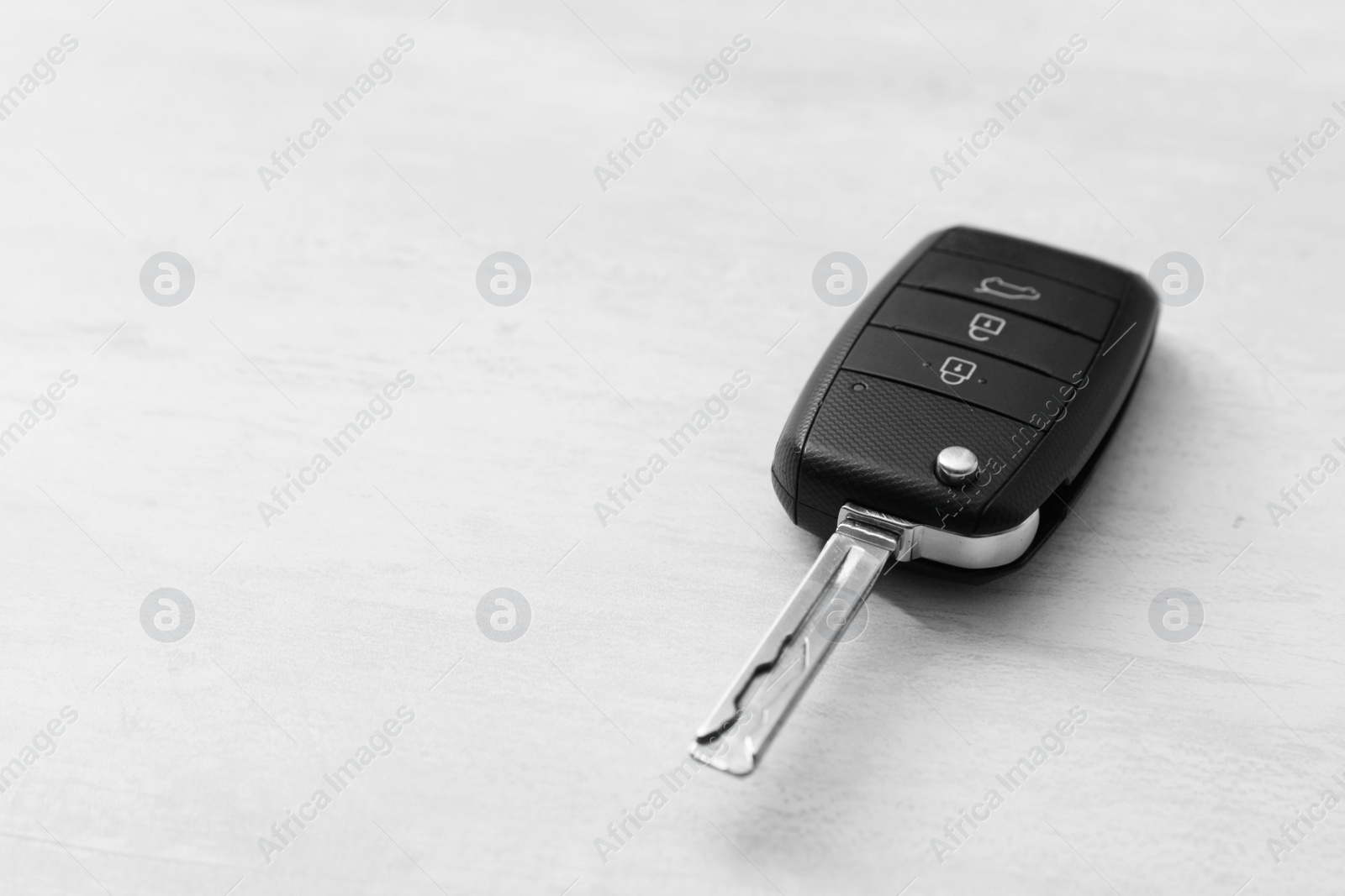 Photo of Car key on light background. Space for text