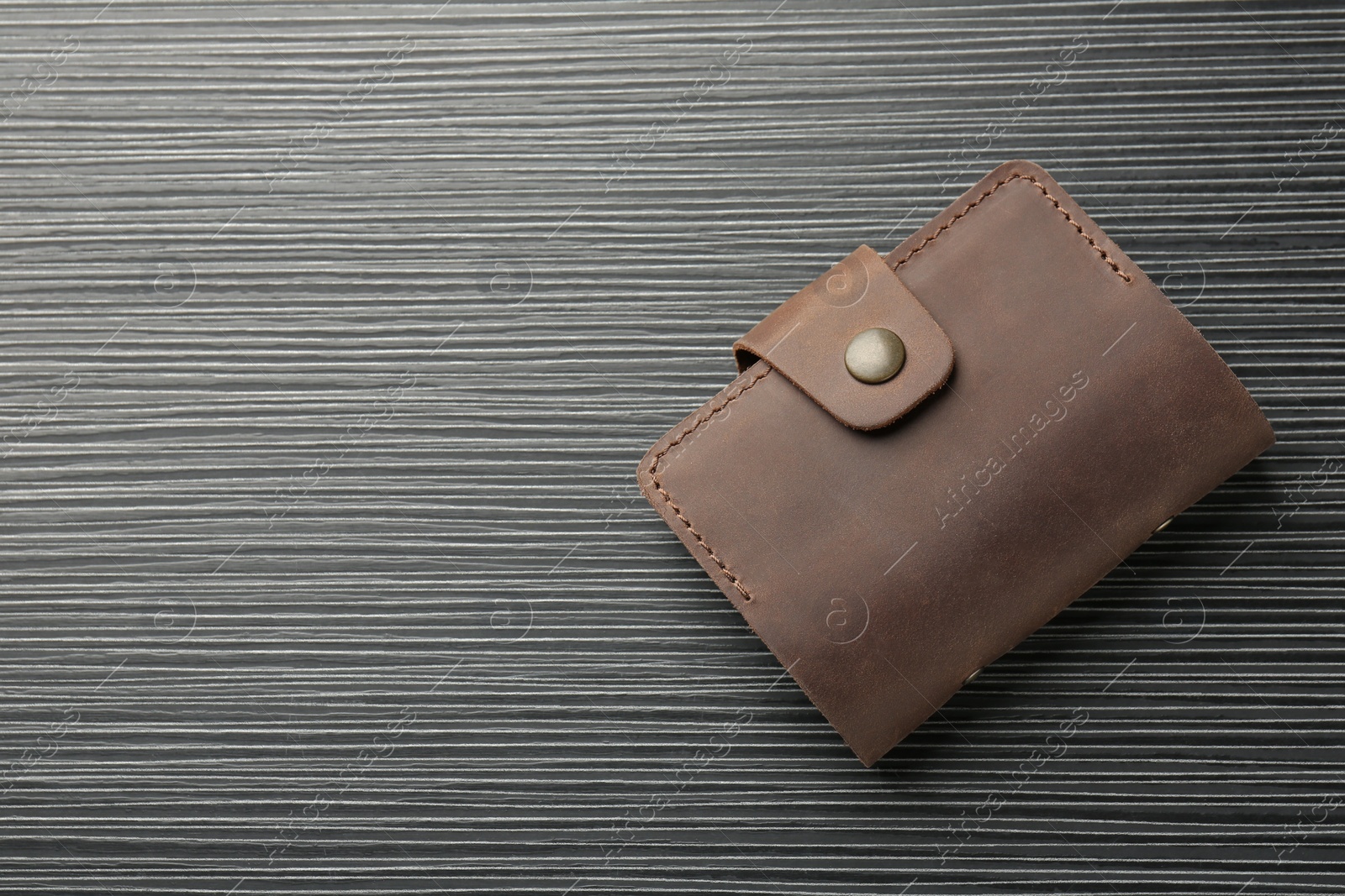 Photo of Leather business card holder on grey table, top view. Space for text