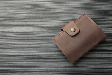 Photo of Leather business card holder on grey table, top view. Space for text