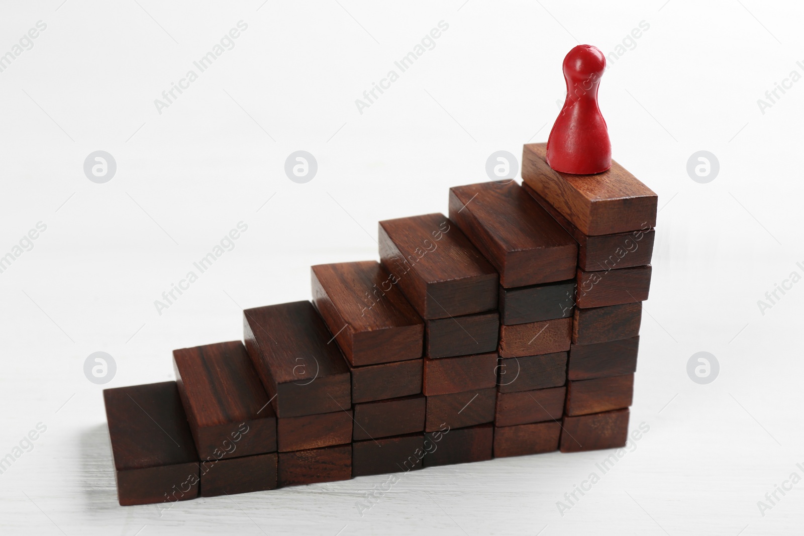 Photo of Red game piece on top of pyramid. Career promotion concept