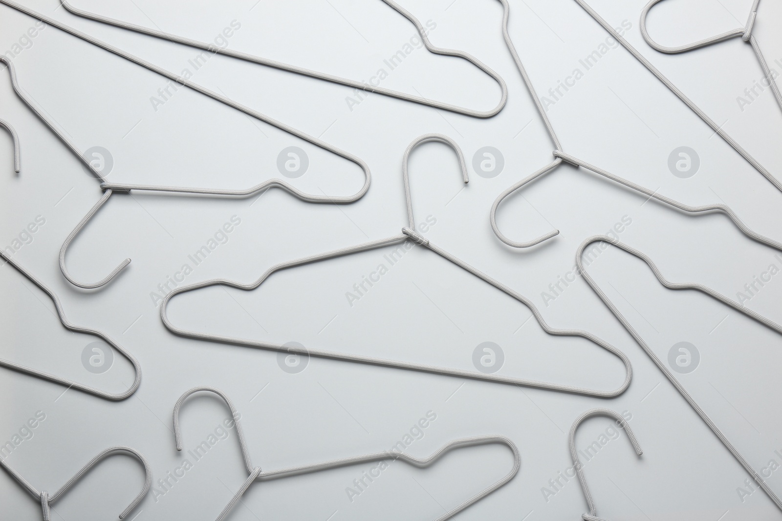 Photo of Hangers on light gray background, flat lay