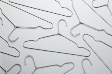 Photo of Hangers on light gray background, flat lay