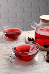 Tasty fresh hibiscus tea on wooden table