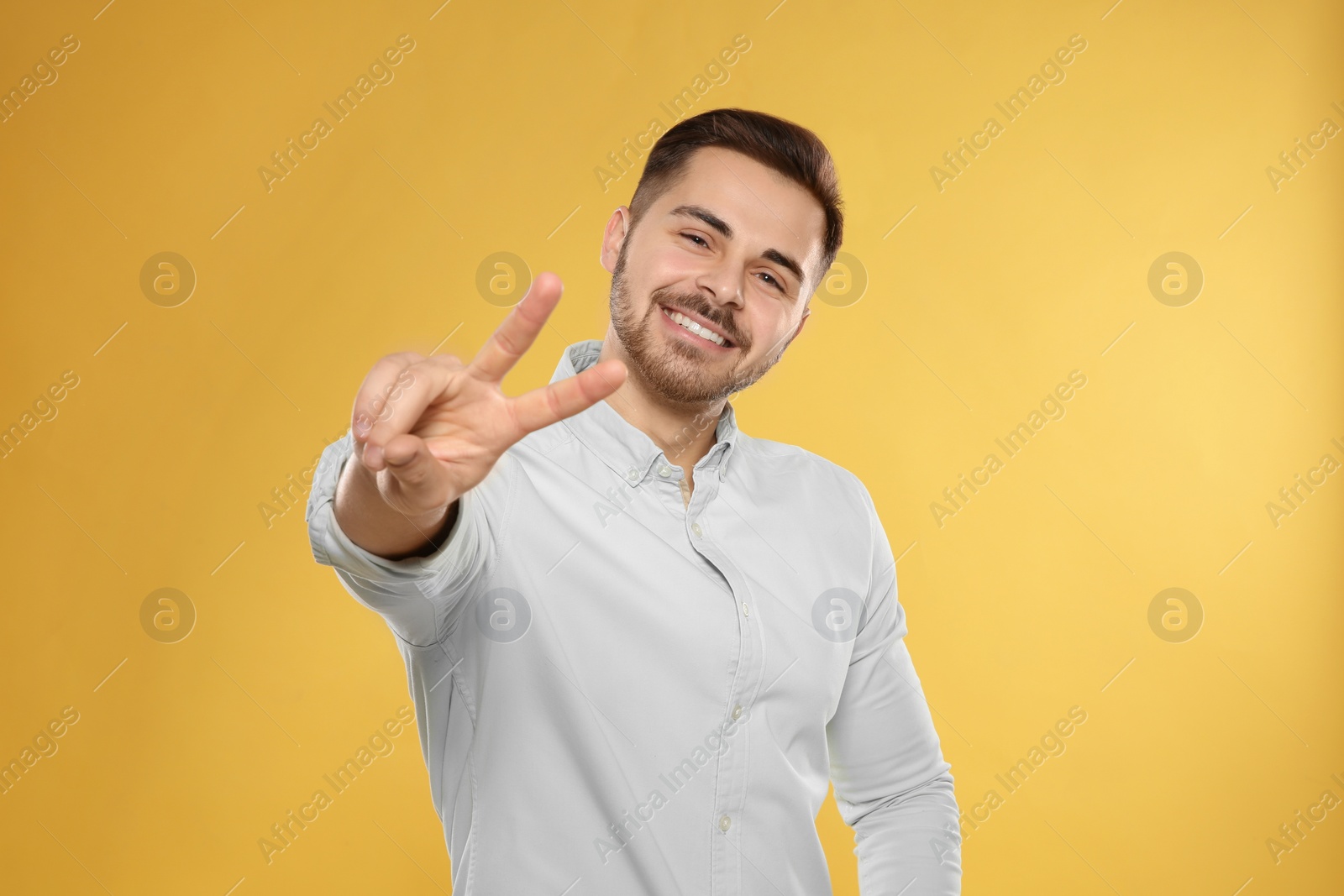 Photo of Portrait of handsome young man on color background