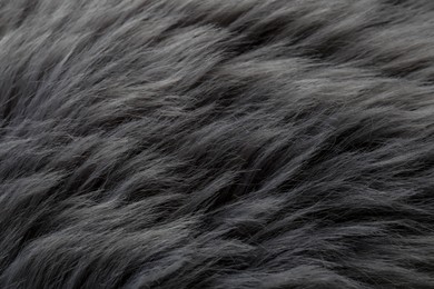 Photo of Beautiful grey faux fur as background, closeup view
