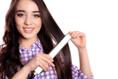 Photo of Happy woman using hair iron on white background