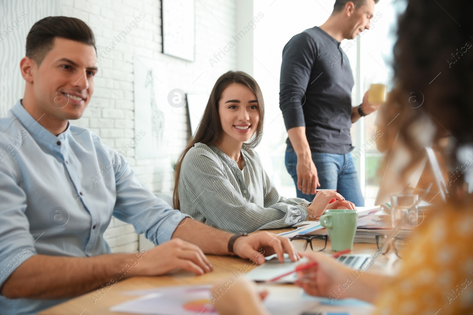 Photo of Team of professional designers working in office