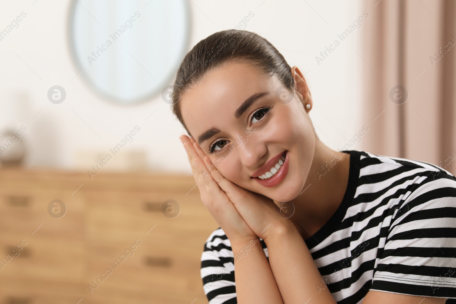 Photo of Portrait of beautiful young woman indoors, space for text. Attractive lady smiling and looking into camera