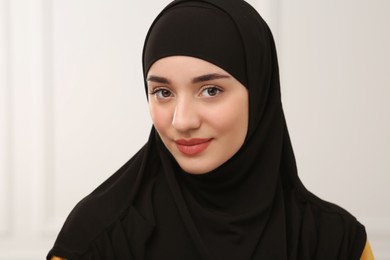 Photo of Portrait of Muslim woman in hijab indoors