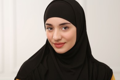 Portrait of Muslim woman in hijab indoors