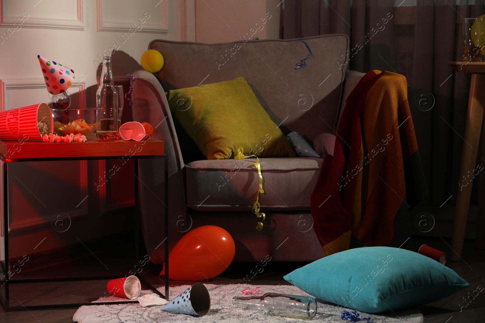 Photo of Armchair and dirty table in messy room after party