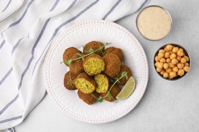 Delicious falafel balls served on light table, flat lay