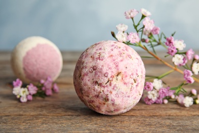 Bath bomb and flowers on wooden table