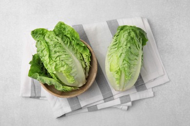 Photo of Fresh green romaine lettuces on grey table, flat lay