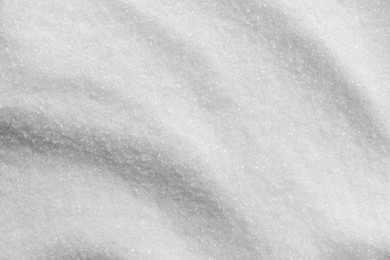 White granulated sugar as background, top view