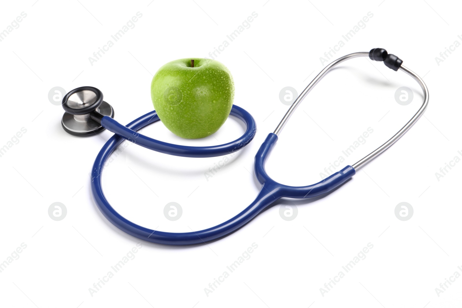 Image of Stethoscope and green apple on white background 