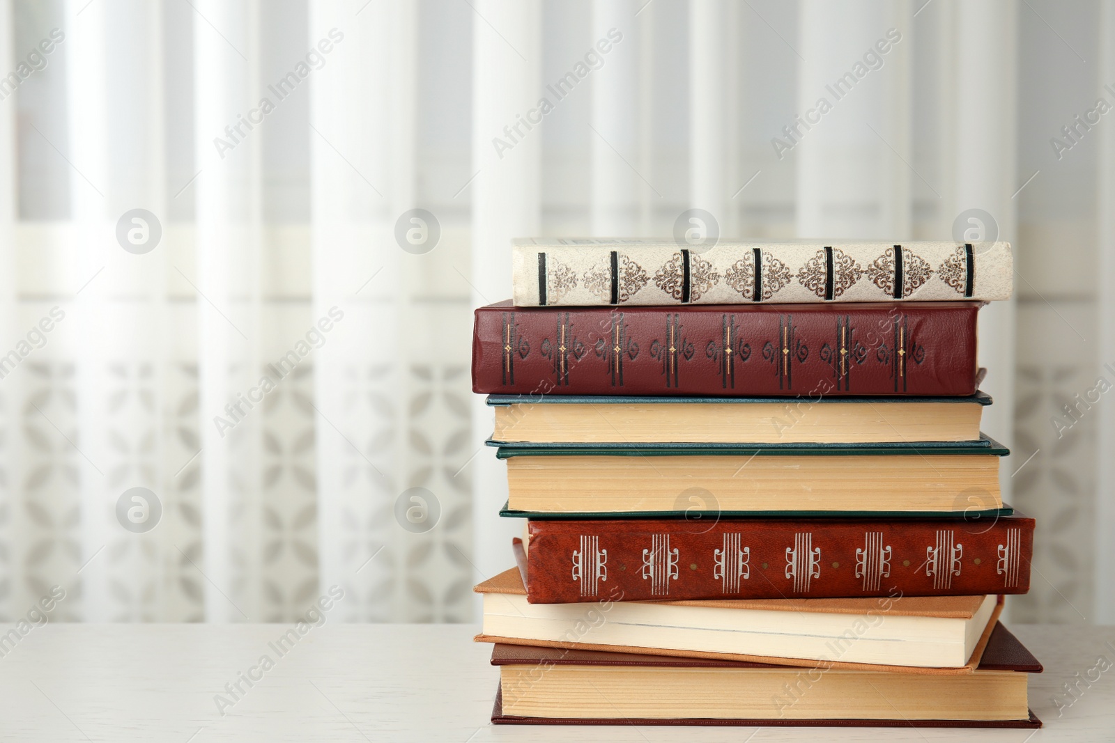 Photo of Collection of different books on table indoors. Space for text