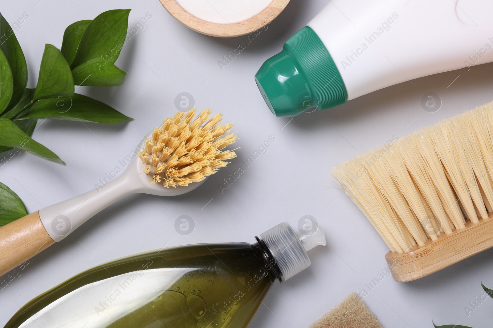 Photo of Flat lay composition with different cleaning supplies on light gray background