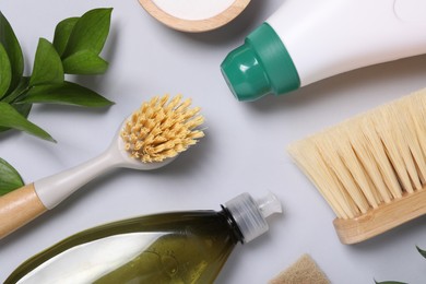 Photo of Flat lay composition with different cleaning supplies on light gray background