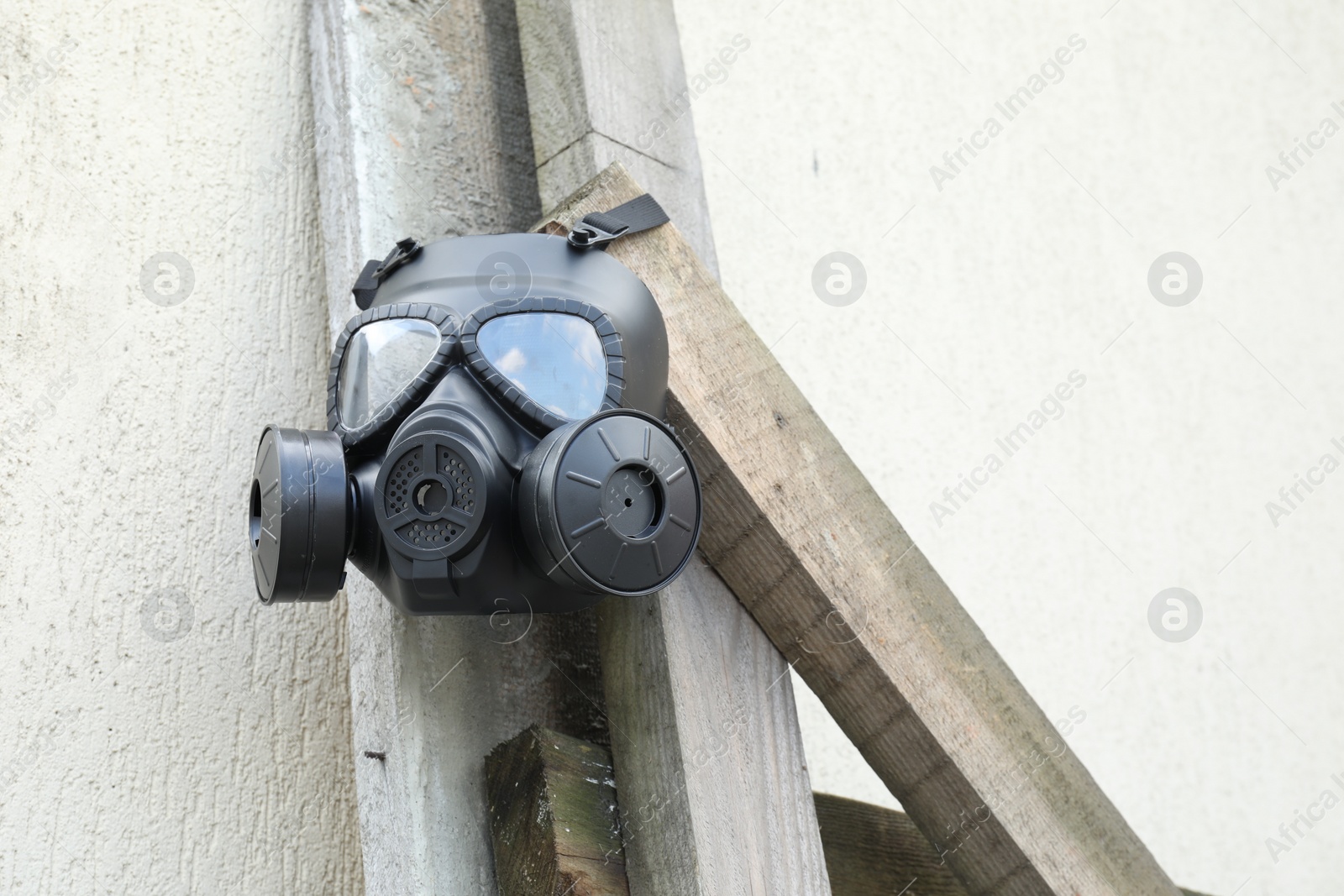 Photo of One gas mask hanging on building outdoors, low angle view