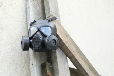 One gas mask hanging on building outdoors, low angle view