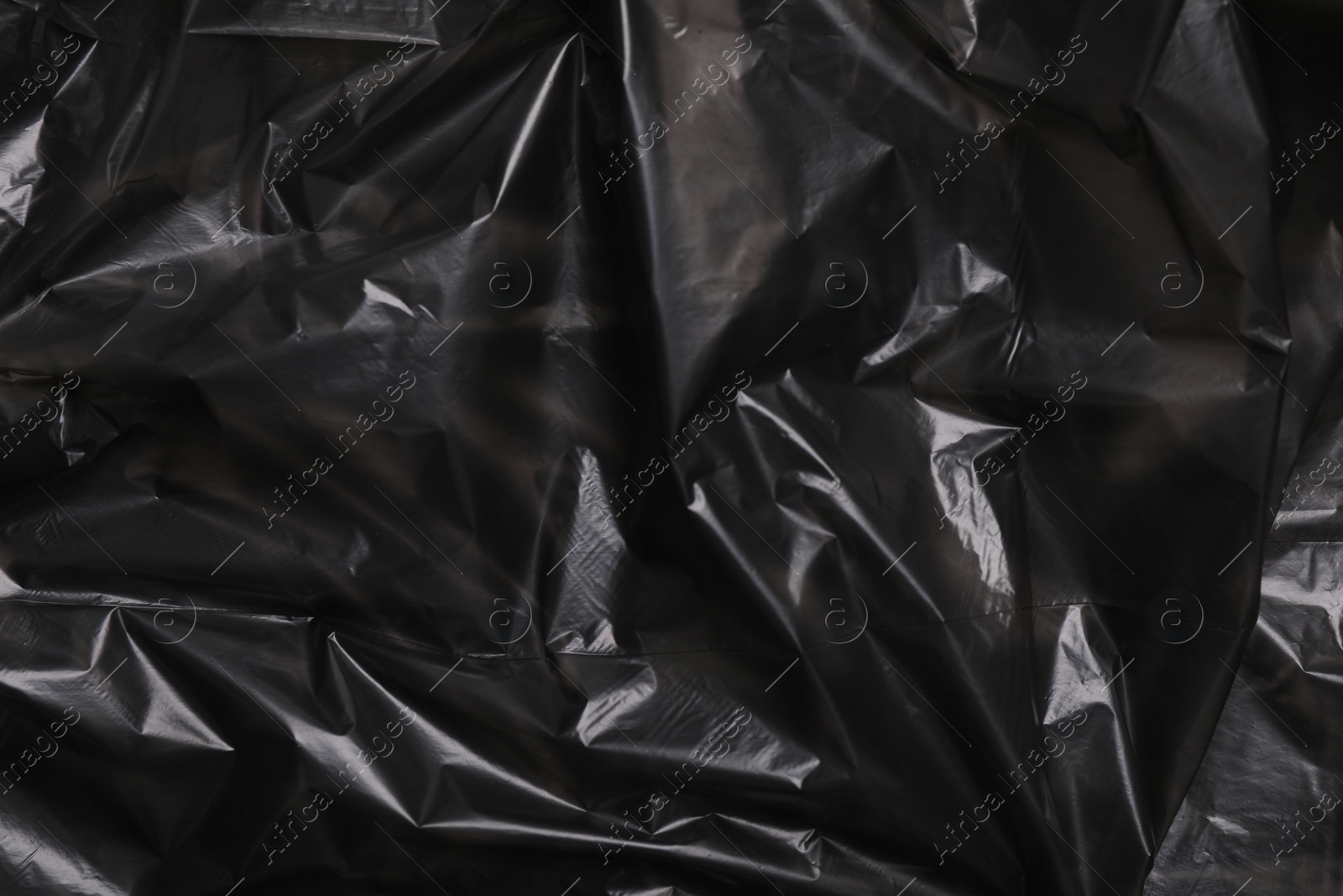 Photo of Texture of black plastic bag as background, closeup