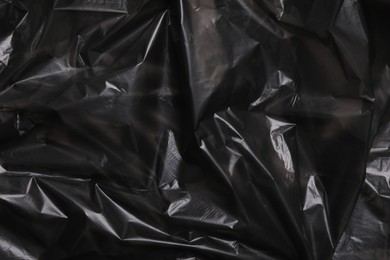 Texture of black plastic bag as background, closeup