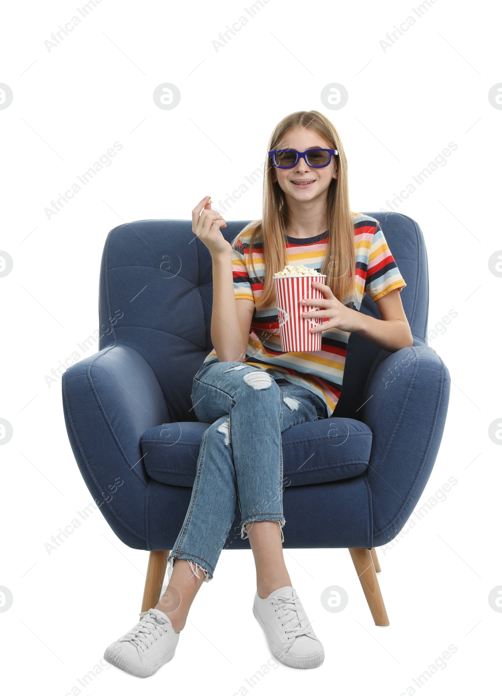 Photo of Teenage girl with 3D glasses and popcorn sitting in armchair during cinema show on white background