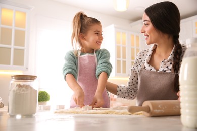 Mother and daughter making pastry in kitchen at home