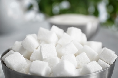 Photo of bowl with refined sugar cubes, closeup