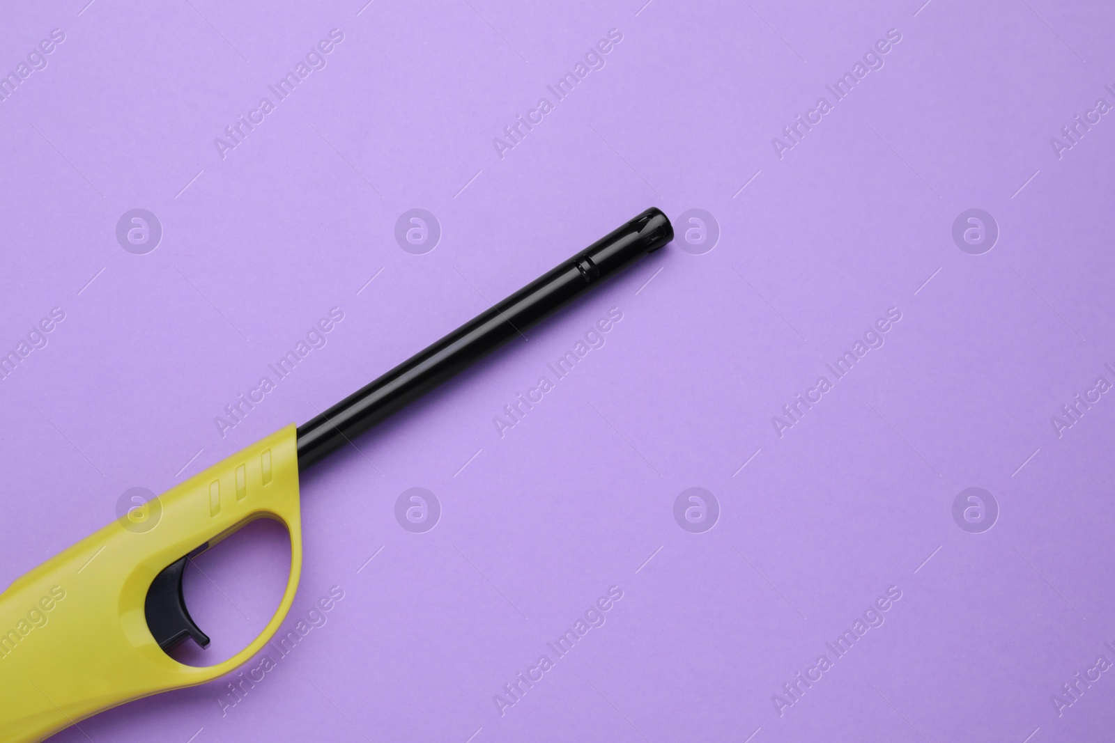 Photo of One gas lighter on violet background, top view. Space for text