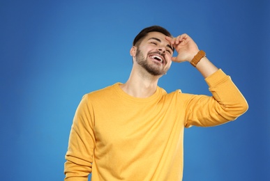 Photo of Portrait of handsome young man on color background