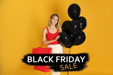 Happy young woman with balloons and shopping bag on yellow background. Black Friday Sale