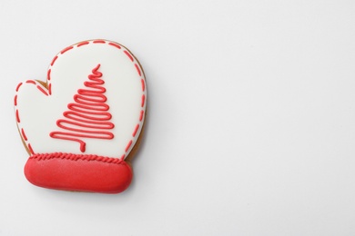 Photo of Christmas mitten shaped gingerbread cookie on white background, top view