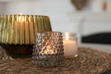Photo of Burning candles in beautiful glass holders on table indoors, closeup. Space for text