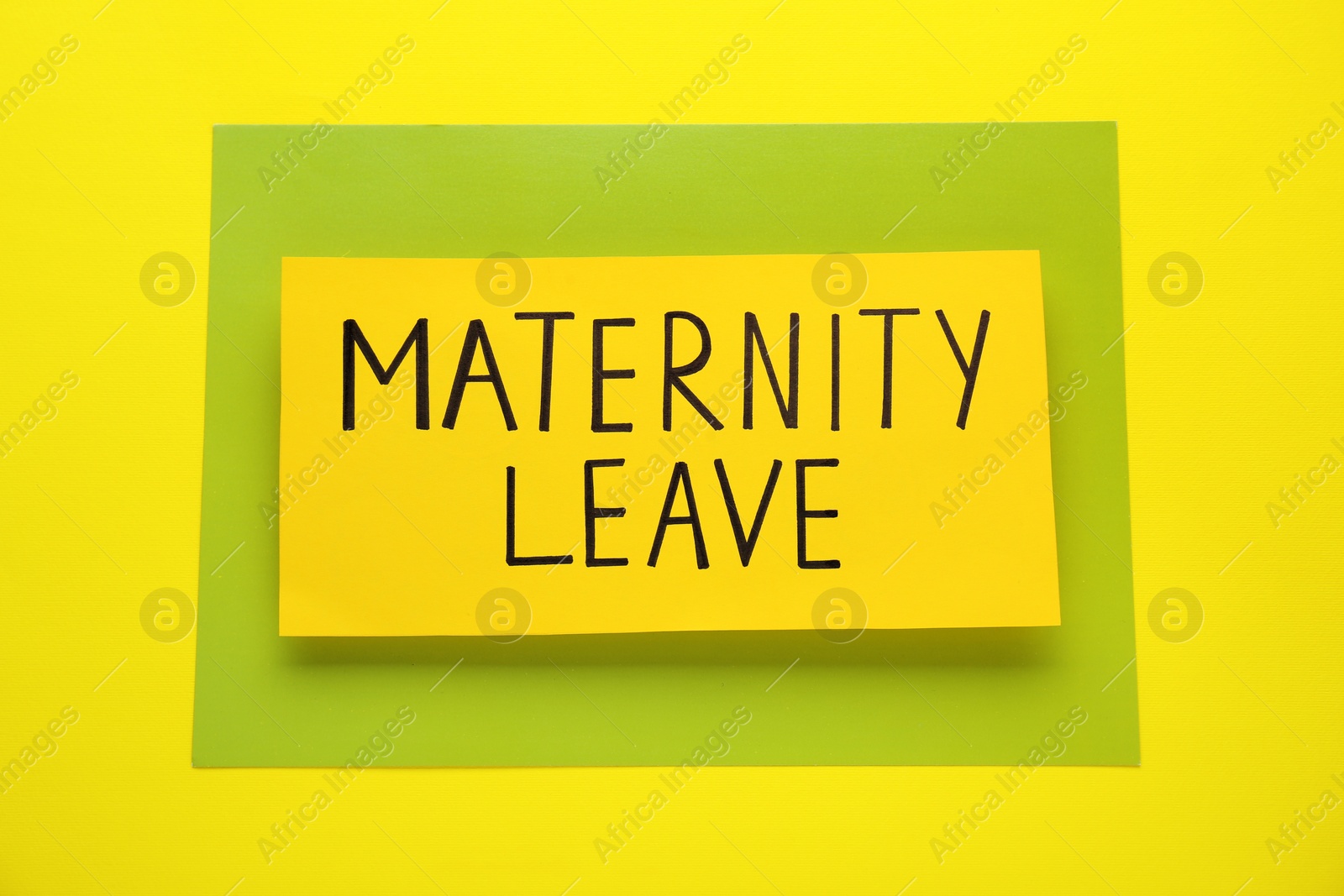 Photo of Note with words Maternity Leave on yellow background, top view