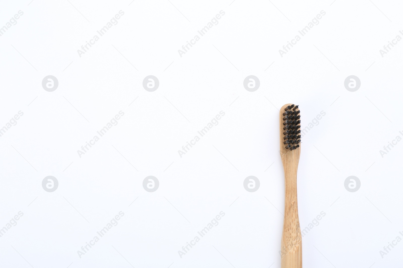 Photo of Bamboo toothbrush with charcoal bristle isolated on white, top view