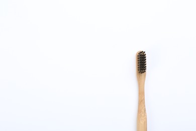 Bamboo toothbrush with charcoal bristle isolated on white, top view