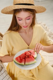 Photo of Beautiful teenage girl with slices of watermelon indoors