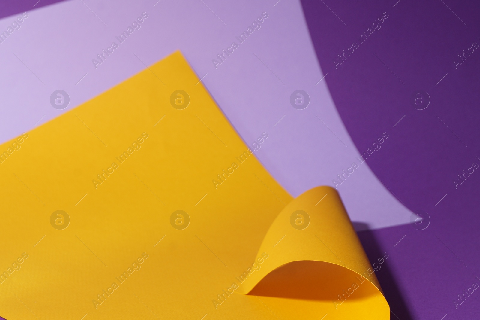 Photo of Different colorful paper sheets on purple background