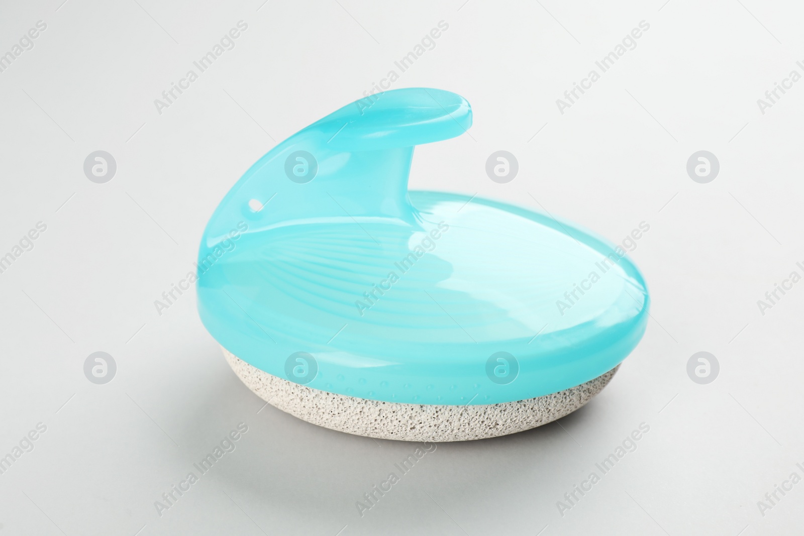 Photo of Pedicure tool with pumice stone on light background