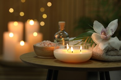 Composition with different spa products and orchid flower on wooden table