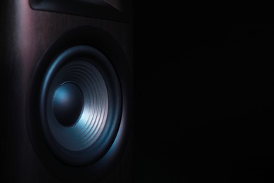 Photo of One sound speaker on black background, closeup. Space for text