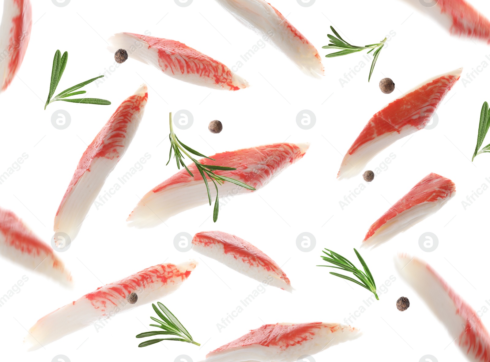 Image of Cut fresh crab sticks, rosemary and allspice falling on white background