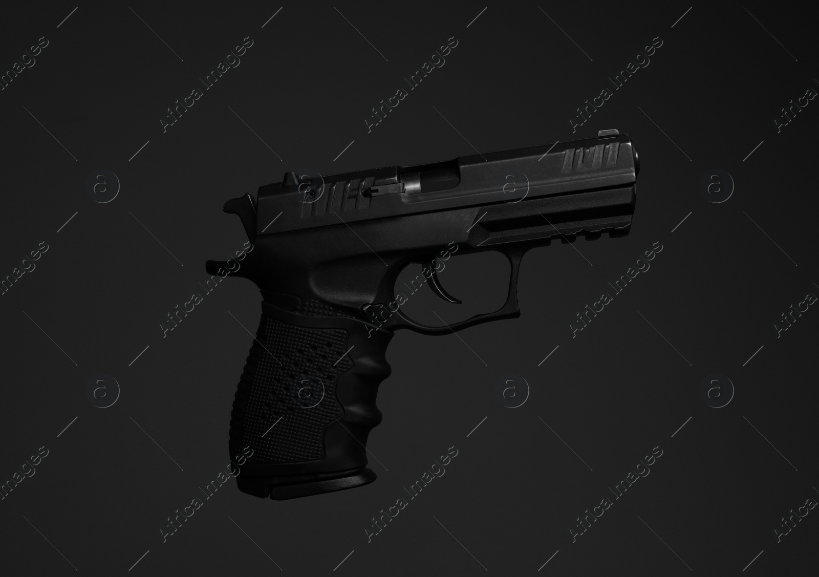 Photo of Standard handgun on dark background. Semi-automatic pistol