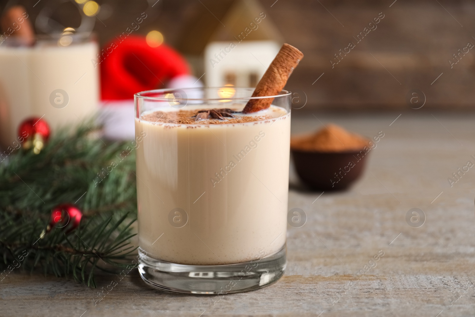 Photo of Delicious Christmas liqueur on wooden table, closeup